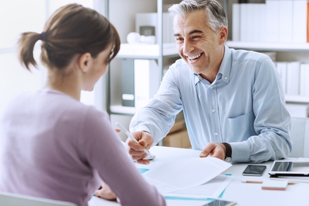 Job interview between elderly man and young woman